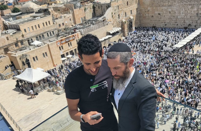  Nuseir Yassin with Rabbi Dov Ber Cohen on the roof of the Dan Family Aish World Center. (photo credit: AISH.COM)