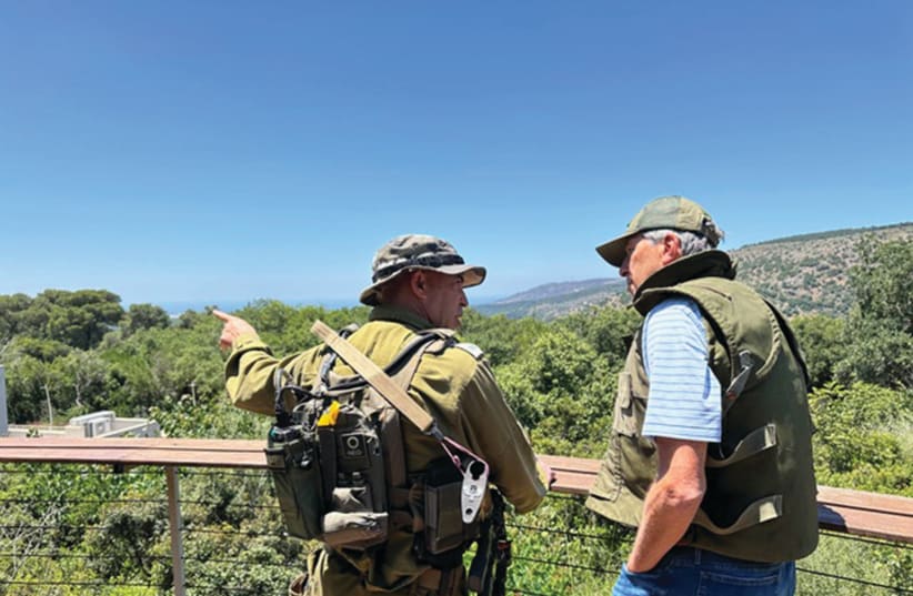  THE WRITER is briefed on the Lebanese border by an IDF expert on Hezbollah missiles.  (photo credit: Courtesy Eric Mandel)
