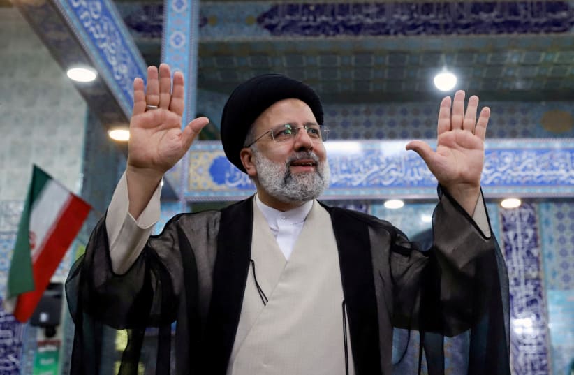   Presidential candidate Ebrahim Raisi gestures after casting his vote during presidential elections at a polling station in Tehran, Iran June 18, 2021. (photo credit: VIA REUTERS)