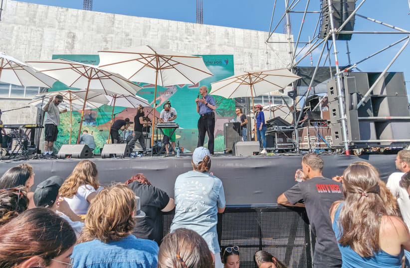  THE WRITER speaks at a music festival in memory of Amir Lavie, killed on October 7 while fighting Hamas terrorists who raided a military base near Gaza. (photo credit: Simone Landau)