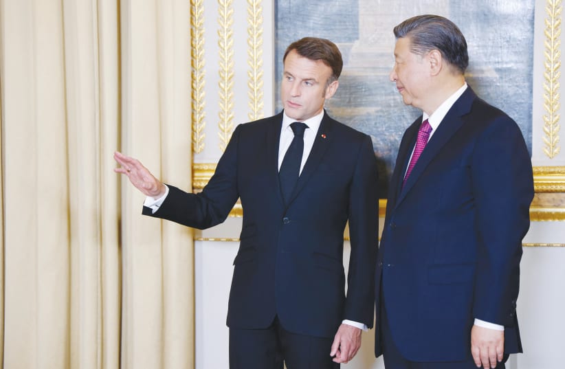  FRANCE’S PRESIDENT Emmanuel Macron speaks with Chinese President Xi Jinping ahead of an official state dinner at the Elysee Palace in Paris, during the Chinese president’s two-day state visit to France, earlier this month. (photo credit: LUDOVIC MARIN/REUTERS)