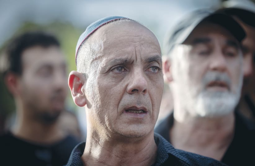  SHANI LOUK’S father, Nissim, looks on at Shani’s funeral this week, after her body was retrieved by the IDF from the Gaza Strip. Shani was murdered on October 7 as she tried to escape the Hamas massacre at the Supernova music festival.  (photo credit: Chaim Goldberg/Flash90)