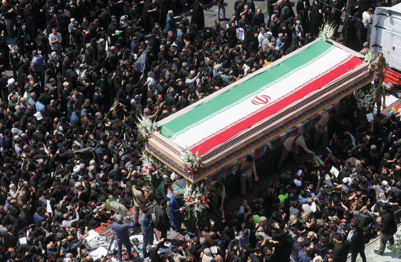  MOURNERS ATTEND the funeral for victims of helicopter crash that killed Iran’s President Ebrahim Raisi, Foreign Minister Hossein Amir-Abdollahian, and others,  in Tehran, on Tuesday.  (photo credit: MAJID ASGARIPOUR/WANA/REUTERS)