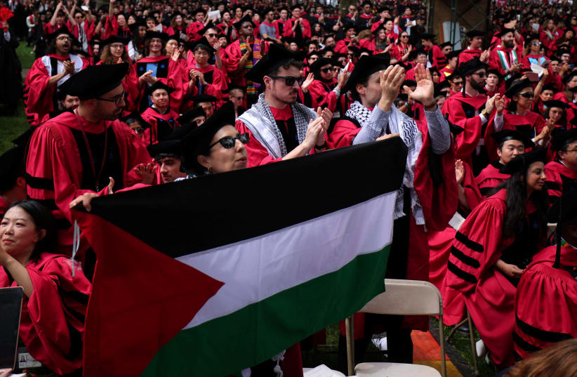  Graduating students rise in support of 13 students not able to graduate because of their participation in pro-Palestinian protests during the 373rd Commencement Exercises at Harvard University, amid the ongoing conflict between Israel and Hamas, May 23, 2024. (photo credit: REUTERS/BRIAN SNYDER)