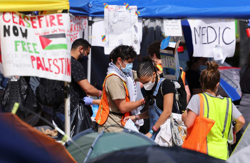  Protestors supporting Palestinians in Gaza gather at an encampment at the University of California Los Angeles (UCLA), as the conflict between Israel and the Palestinian Islamist group Hamas continues, in Los Angeles, California, US, May 1, 2024. (photo credit: REUTERS/MIKE BLAKE)