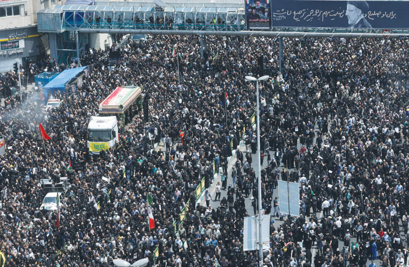  MOURNERS ATTEND a funeral in Tehran, last week, for victims of the helicopter crash that killed Iran’s president Ebrahim Raisi, foreign minister Hossein Amirabdollahian and others. (photo credit: WEST ASIA NEWS AGENCY/REUTERS)