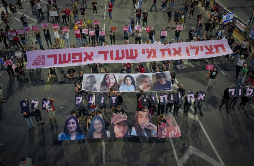  Demonstrators hold images of five female soldiers held hostage by Hamas terrorists in Gaza, as they protest calling for the release of all hostages held in the Gaza Strip and against the current Israeli government outside the Ministry of Defense in Tel Aviv, May 25, 2024. (photo credit: ERIK MARMOR/FLASH90)