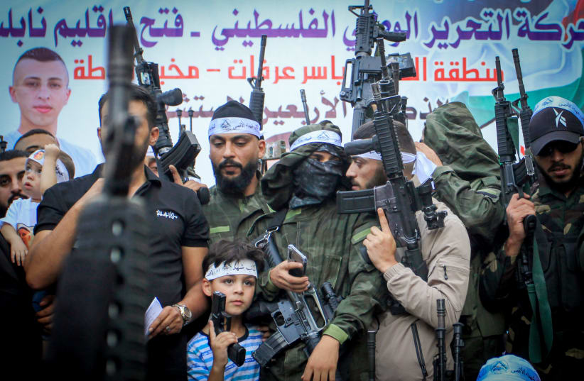  Palestinian terrorists from Fatah carry their weapons during a parade in the Balata refugee camp in the West Bank city of Nablus, September 29, 2023 (photo credit: NASSER ISHTAYEH/FLASH90)
