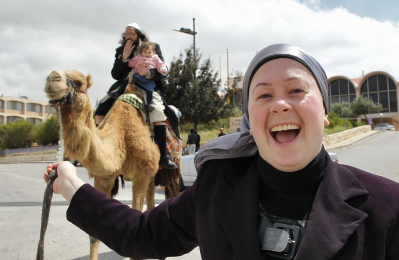 HORSING AROUND and letting loose with a camel in Jerusalem’s Old City. (photo credit: FLASH90)