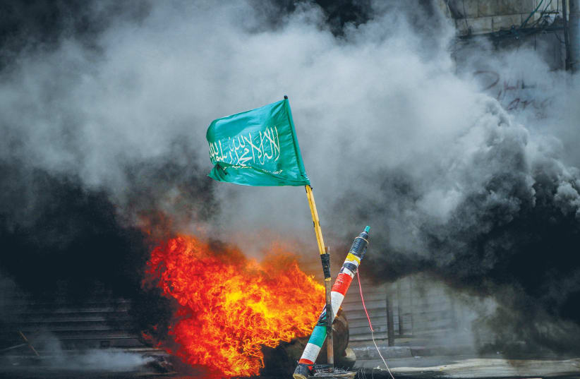  A HAMAS flag flies in Jenin, the West Bank, last month, amid a Palestinian protest against activity by Israeli security forces. (photo credit: NASSER ISHTAYEH/FLASH90)