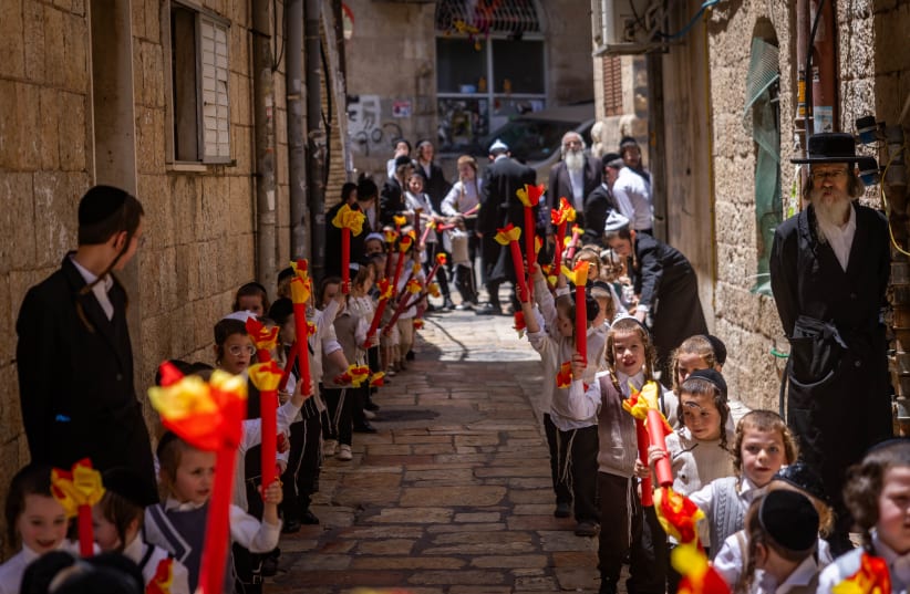  Ultra-Orthodox kids march during Shavuot celebrations in Mea She'arim, Jerusalem, June 9, 2024 (photo credit: Chaim Goldberg/Flash90)