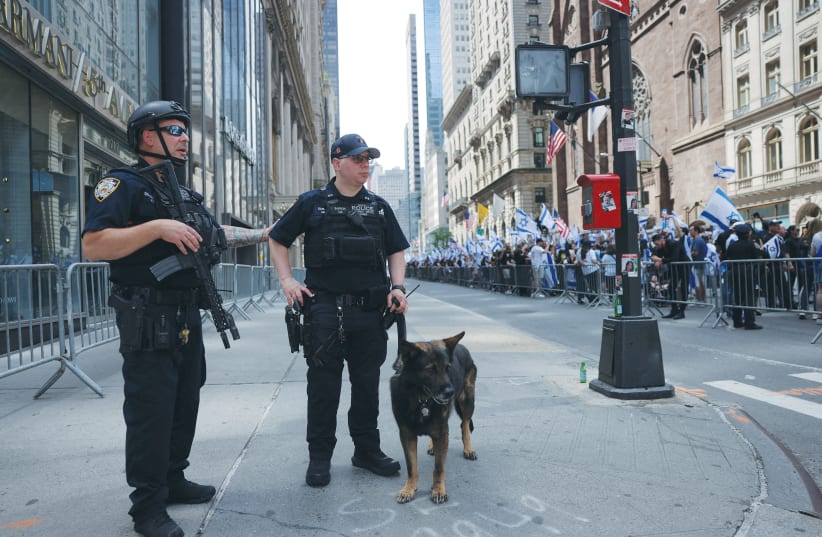  POLICE OFFICERS stand guard as people take part in Israel Day on Fifth Parade in New York City on June 2. (photo credit: Andrew Kelly/Reuters)