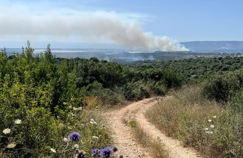  Smoke rises above the Israeli side of the Israel-Lebanon border following attacks from Lebanon, amid cross-border hostilities between Hezbollah and Israeli forces, in northern Israel June 18, 2024.  (photo credit: REUTERS/Avi Ohayon)