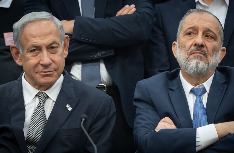  Shas leader MK Arye Deri and Prime Minister Benjamin Netanyahu seen at the Knesset, in Jerusalem, on January 23, 2023 (photo credit: YONATAN SINDEL/FLASH90)