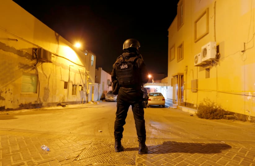 A Special Force personnel guards an entrance to the crime scene where a blast killed one and seriously injured two police officers in the village of Diraz west of Manama, Bahrain, June 19, 2017. (photo credit: HAMAD I MOHAMMED/REUTERS)