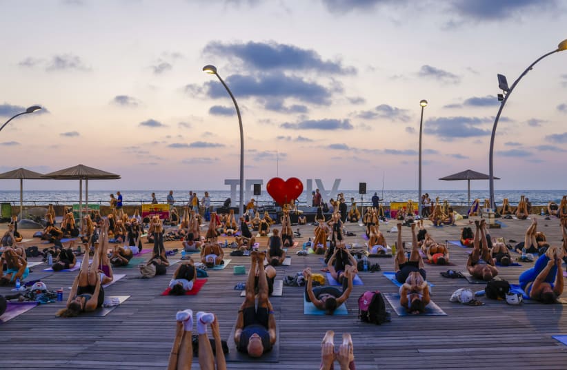  International Yoga Day at the Tel Aviv Port, with yoga and meditation to honor Gaza hostage Carmel Gat.  (photo credit: GUY YEHIELI)