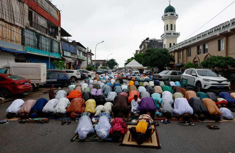 Faithful attend the prayer marking the Eid al-Adha festival, at the Grand Mosque of the Avenue 8 in Treichville, a district of Abidjan, Ivory Coast June 16, 2024 (photo credit: REUTERS/LUC GNAGO)