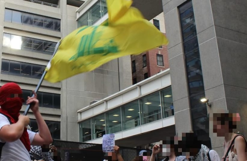  A protest waves a Hezbollah flag at a June 21 Hunter College protest. (photo credit: Screenshot/Instagram page pf NYC Resistance Coalition)