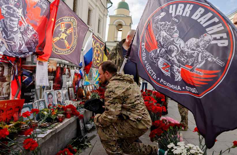  People visit a makeshift memorial for Yevgeny Prigozhin, head of the Wagner mercenary group, and Dmitry Utkin, the group commander, while marking 40 days since their death to respect an Orthodox tradition, in central Moscow, Russia, October 1, 2023. (photo credit: REUTERS/EVGENIA NOVOZHENINA)