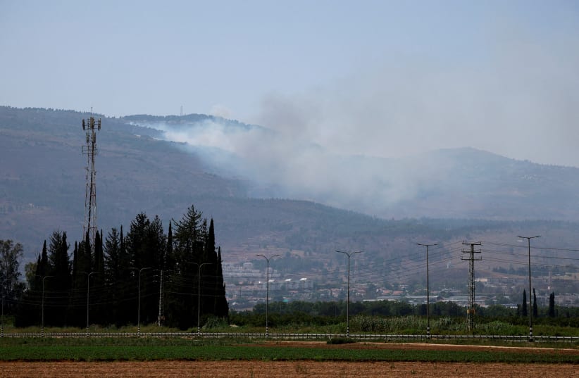  Smoke rises, amid ongoing cross-border hostilities between Hezbollah and Israeli forces, in Kiryat Shmona, northern Israel, June 14, 2024. (photo credit: AMMAR AWAD/REUTERS)