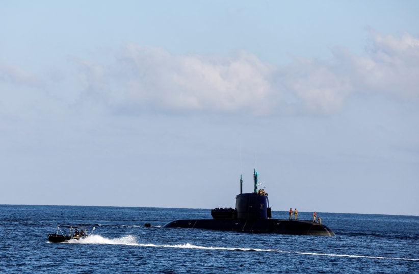  A military boat escorts an Israeli military submarine near the coast of Haifa at the Mediterranean sea, Israel July 25, 2022. (photo credit: REUTERS/NIR ELIAS)