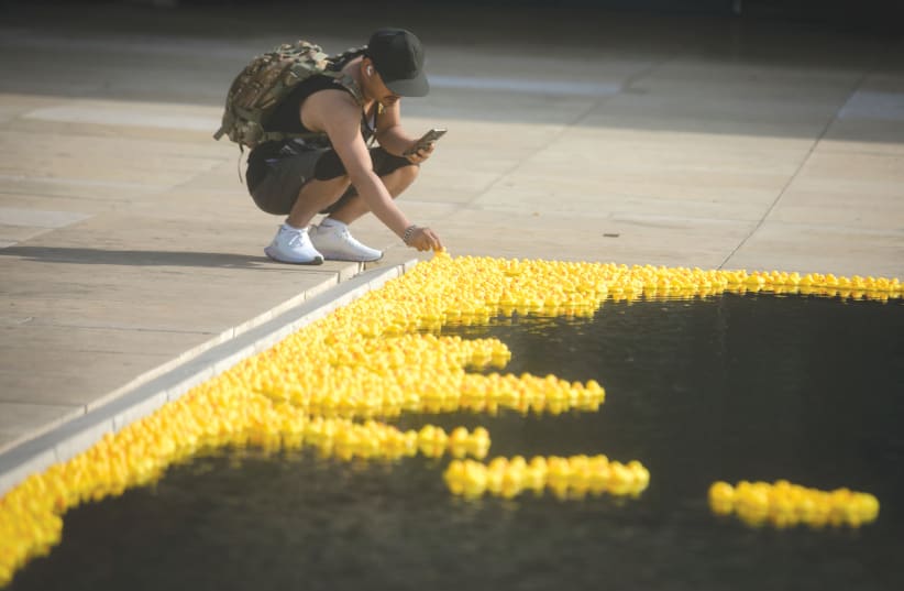  YELLOW RUBBER ducks are on display, symbolizing the call for the release of the hostages held in Gaza, at Habima Square in Tel Aviv. Hindsight was thrust upon us by the subhuman attacks of Hamas.  (photo credit: MIRIAM ALSTER/FLASH90)
