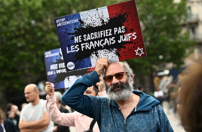  People attend a demonstration against antisemitism in front of Paris City Hall after three teenagers aged 12 to 13 indicted in Courbevoie, accused of rape and anti-Semitic violence against a 12-year-old girl, in Paris, France, June 19, 2024. The slogan reads "Do not sacrifice the French Jews". (photo credit: REUTERS/DYLAN MARTINEZ)