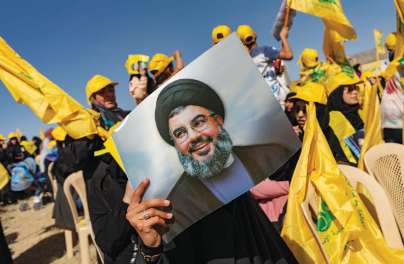  HOISTING A photo of Hezbollah Secretary-General Hassan Nasrallah at a rally in Bekaa Valley, Lebanon. (photo credit: Francesca Volpi/Getty Images)
