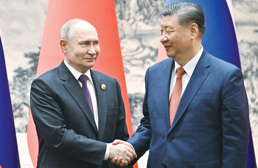  RUSSIAN PRESIDENT Vladimir Putin shakes hands with Chinese President Xi Jinping during a meeting in Beijing, last month.  (photo credit: SPUTNIK/REUTERS)