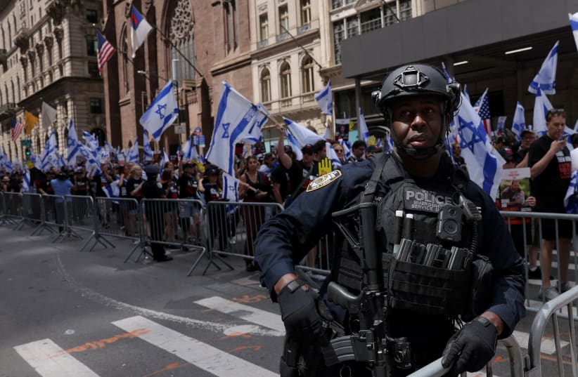  A police officer stands guard as people take part in Israel Day on Fifth Parade, amid the ongoing conflict between Israel and the Palestinian Islamist group Hamas, in New York City, U.S., June 2, 2024 (photo credit: REUTERS/ANDREW KELLY)