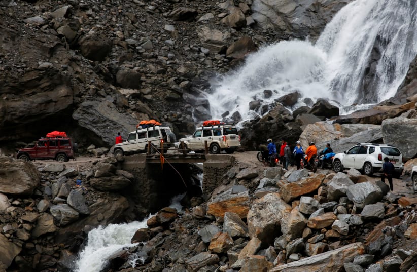 Vehicles get stuck at an area affected by landslide due to bad road conditions after three days of heavy rain at Myagdi, Nepal, October 20, 2021.  (photo credit: NAVESH CHITRAKAR/REUTERS)