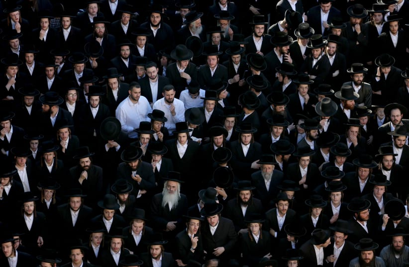  Ultra-Orthodox Jewish men protest an Israeli Supreme Court ruling that requires the state to begin drafting ultra-Orthodox Jewish seminary students to the military, in the Mea Shearim neighbourhood of Jerusalem, June 30, 2024. (photo credit: RONEN ZVULUN/REUTERS)