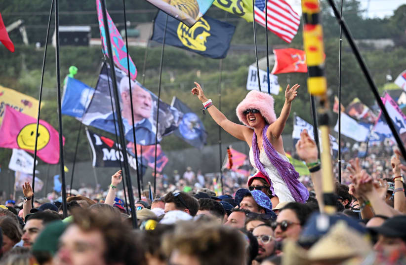  Revellers enjoy as Little Simz performs on the Pyramid Stage during the Glastonbury Festival at Worthy Farm, in Pilton, Somerset, Britain, June 29, 2024. (photo credit: DYLAN MARTINEZ/REUTERS)