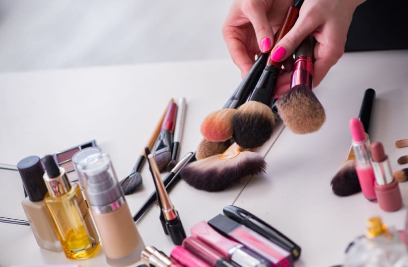  Collection of make up products displayed on the table (photo credit: INGIMAGE)