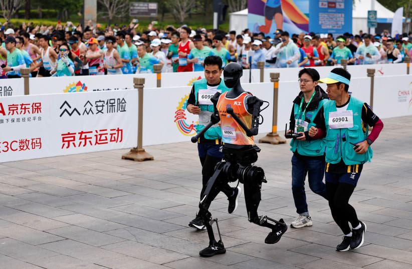 Humanoidalny robot „Tiangong” bierze udział wraz z ludzkimi biegaczami w półmaratonie E-Town i półmaratonie robotów humanoidalnych w Pekinie, Chiny, 19 kwietnia 2025 r. (źródło zdjęcia: REUTERS/TINGSHU WANG)