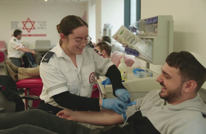  A man donates blood with Magen David Adom. (photo credit: MDA SPOKESPERSON)