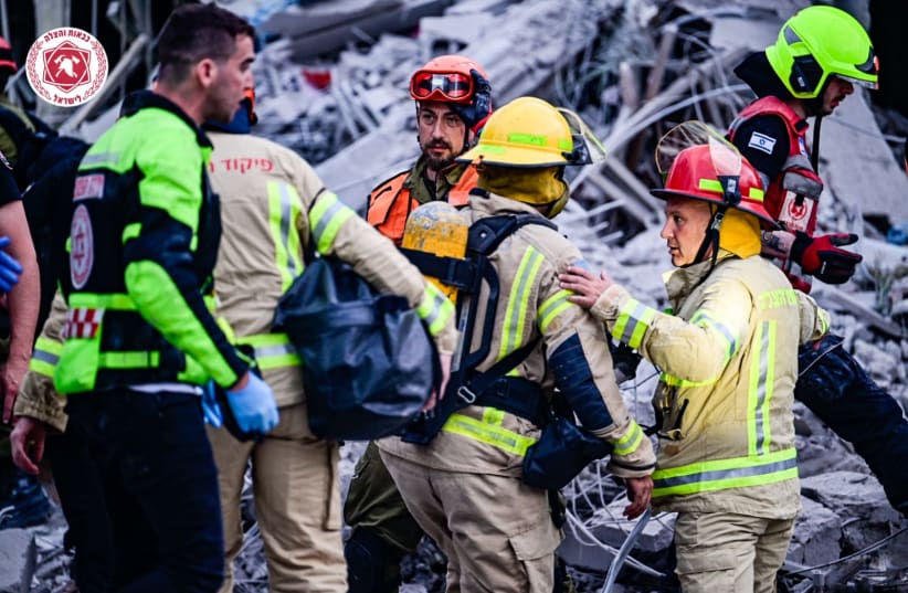  Fire and Rescue Service work to save civilians from the rubble after a Saturday morning Iran attack on June 14, 2025. (photo credit: KOBI RICHTER/ FIRE AND RESCUE)