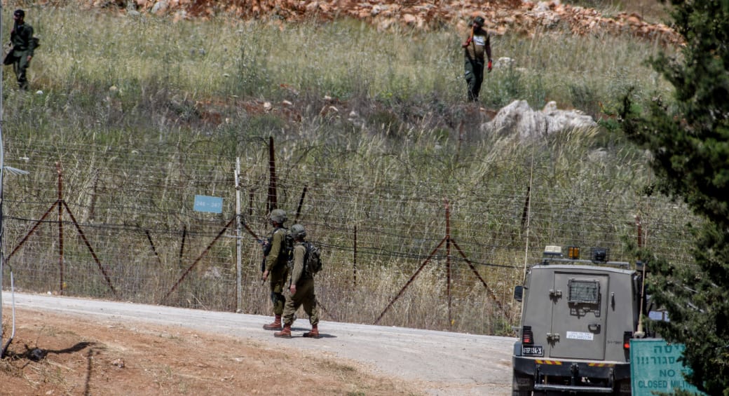  Israeli soldiers guard the northern Israeli border with Lebanon, while Lebanese soldiers work on their side of the border, on May 16, 2023. (photo credit: AYAL MARGOLIN/FLASH90)