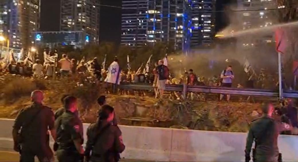  Police use water cannon to clear Ayalon Highway. July 18, 2023 (photo credit: Screenshot/Israel Police)