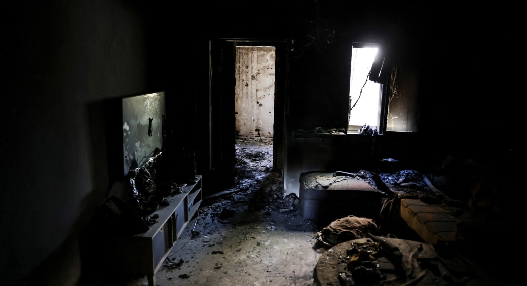  A view shows the living room of a burnt house, following a deadly infiltration by Hamas gunmen from the Gaza Strip, in Kibbutz Kfar Aza in southern Israel, October 15, 2023.  (photo credit: RONEN ZVULUN/REUTERS)