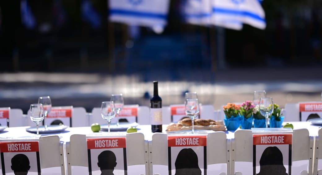  Families of Israelis held hostage by Hamas militants in Gaza set a symbolic shabbat table with more than 200 empty seats for the hostages, at  "Hostage Square", outside the Art Museum of Tel Aviv, October 20, 2023.  (photo credit: TOMER NEUBERG/FLASH90)