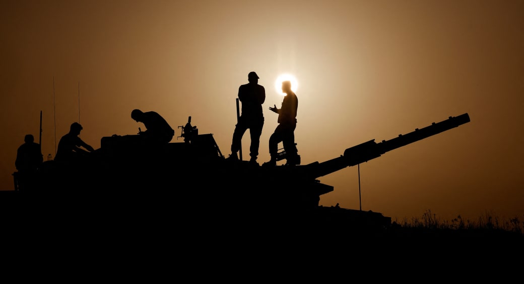  Israeli soldiers stand on a tank, amid the ongoing conflict between Israel and the Palestinian group Hamas, near Israel's border with Gaza in southern Israel, November 23, 2023 (photo credit: REUTERS/AMIR COHEN)