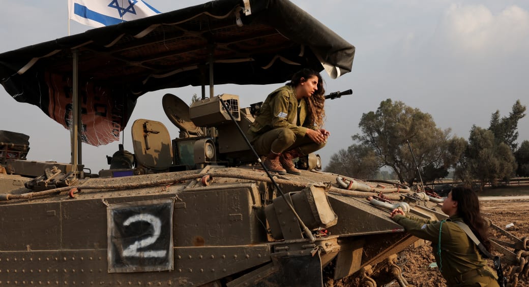  Israeli soldiers ride a military vehicle, in southern Israel, December 28, 2023 (photo credit: REUTERS/VIOLETA SANTOS MOURA)