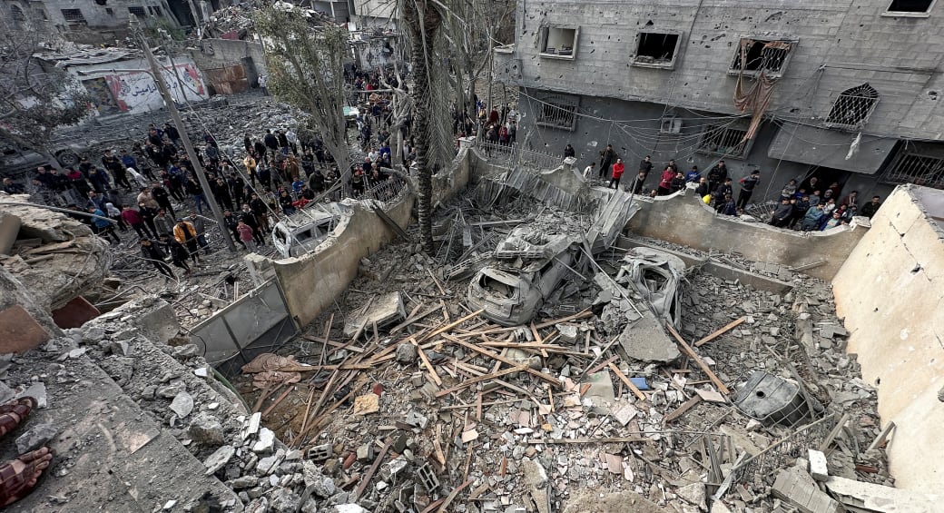  Palestinians inspect the site of an Israeli strike on a house, amid the ongoing conflict between Israel and the Palestinian Islamist group Hamas, in Jabalia in the northern Gaza Strip, January 3, 2024. (photo credit: REUTERS/Emad Gabon)