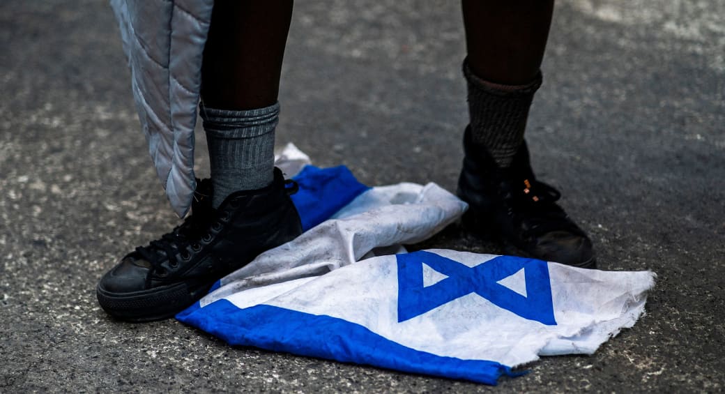  A protester steps on the Israeli flag during a march demanding a ceasefire and the end of Israel's attacks on Gaza, in New York City, U.S., February 22, 2024 (photo credit: Eduardo Munoz/Reuters)