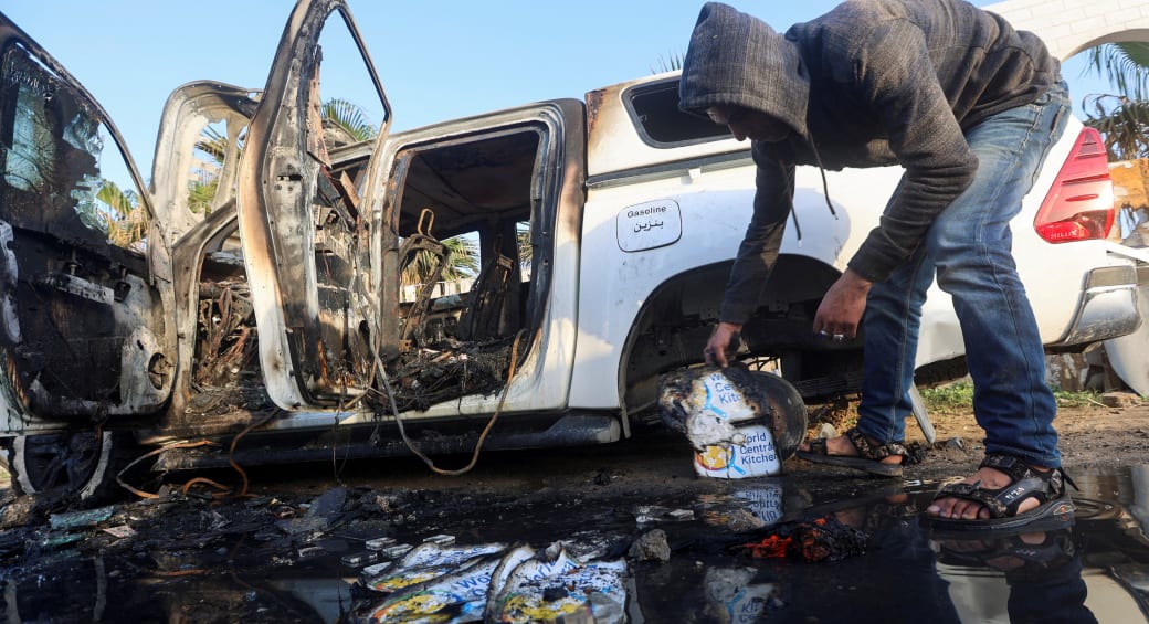  A Palestinian inspects near a vehicle where employees from the World Central Kitchen (WCK), including foreigners, were killed in an Israeli airstrike. April 2, 2024. (photo credit: REUTERS/AHMED ZAKOT)
