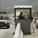 Israeli soldiers check cars at a checkpoint near the West Bank City of Jericho