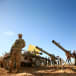  A Hezbollah fighter stands in front of anti-tank artillery at Juroud Arsal