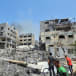  Palestinians inspect a house hit in an Israeli strike in Nuseirat refugee camp, in the central Gaza Strip, June 8, 2024