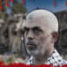 Hamas leader Yahya Sinwar in front of ruins from the October 7 massacre, with a bloody border (illustrative)
